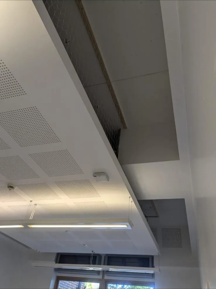 Perforated acoustic plasterboard raft with bulkhead and suspended light fittings