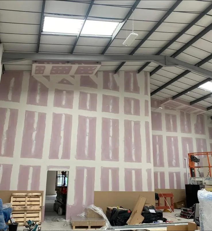 Fire rated plasterboard wall with door opening, taped and jointed ready for decoration