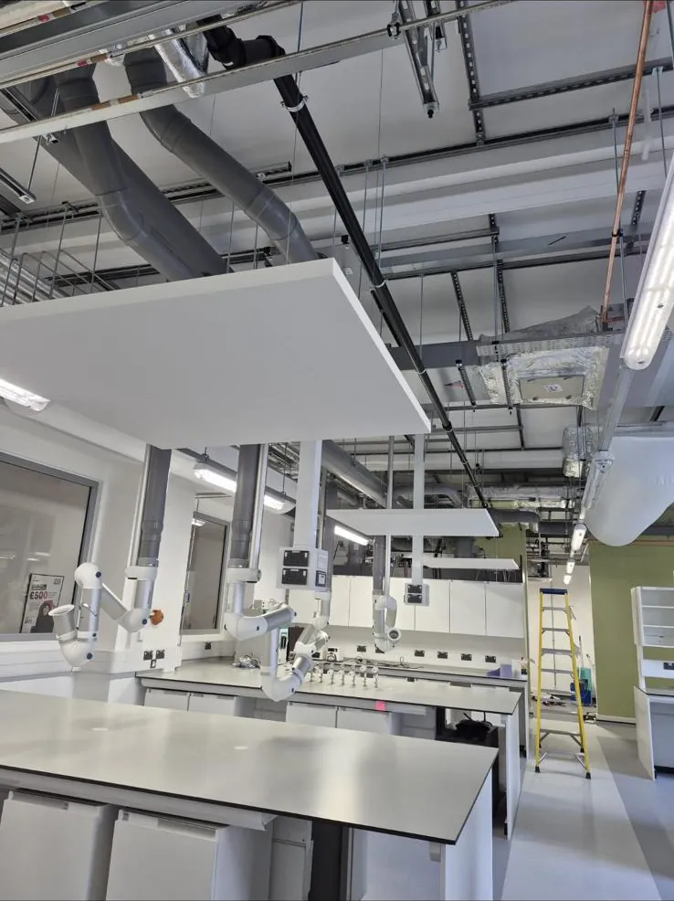 Plasterboard ceiling rafts suspended over laboratory benches with exposed ductwork above