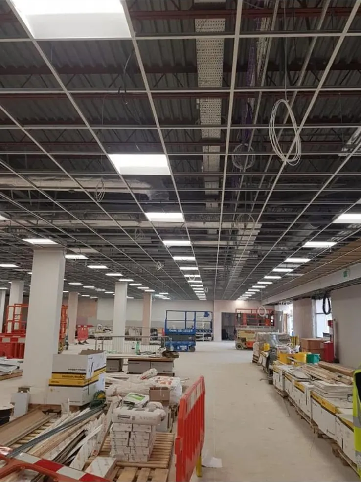 Suspended ceiling grid installed with lighting before tiles go in on a large commercial floor